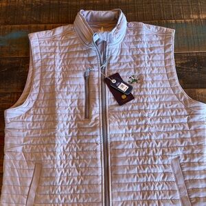 Thin puffer vest with Notre Dame Fighting Irish emblem. Light grey and brand new